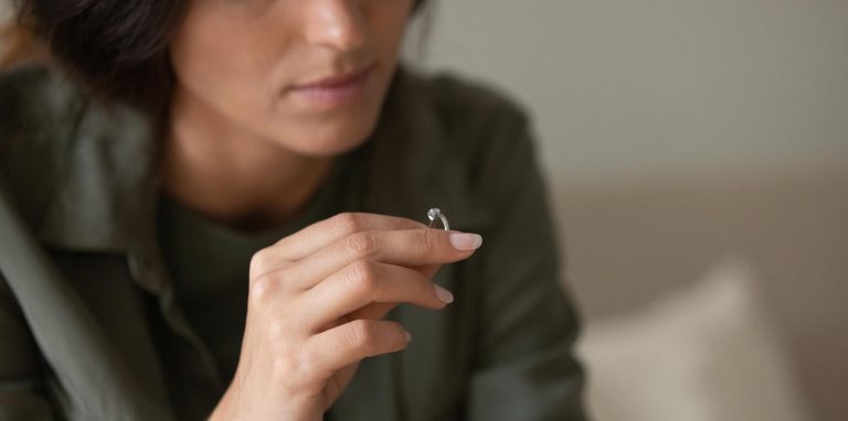woman taking off wedding ring for anullment