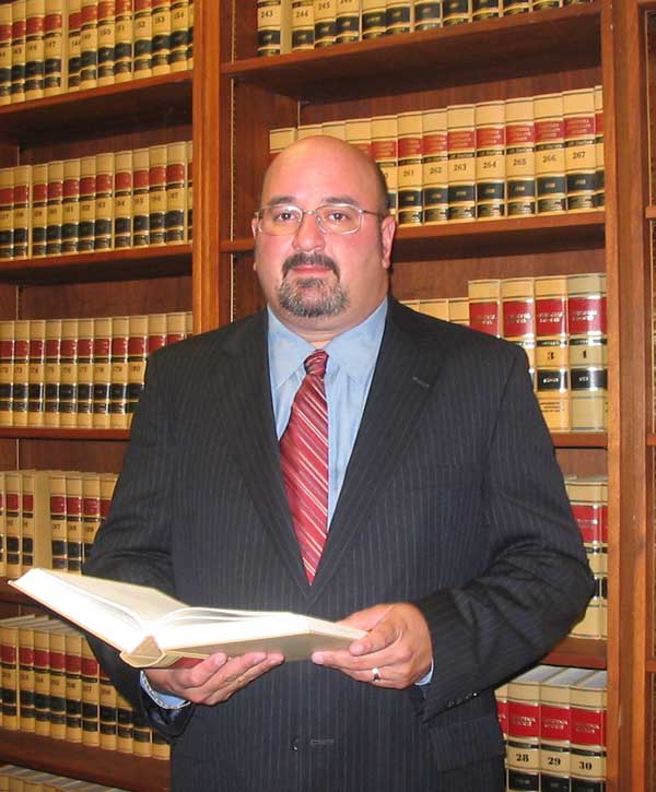Divorce lawyer Charles M. Green in front law library