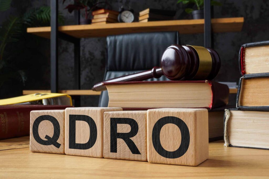 toy wood blocks that spell out "QDRO"